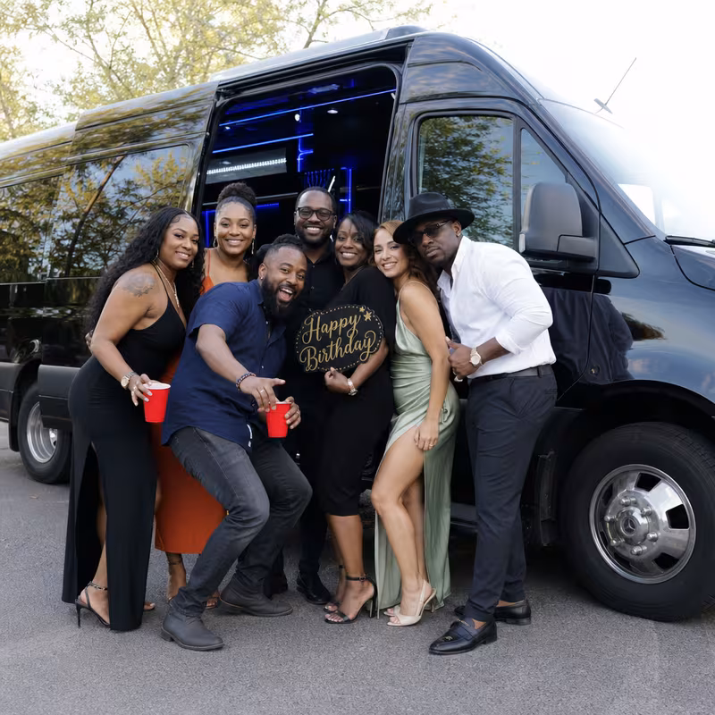 Group boarding a white charter bus for Birthday Transportation transportation in Omaha