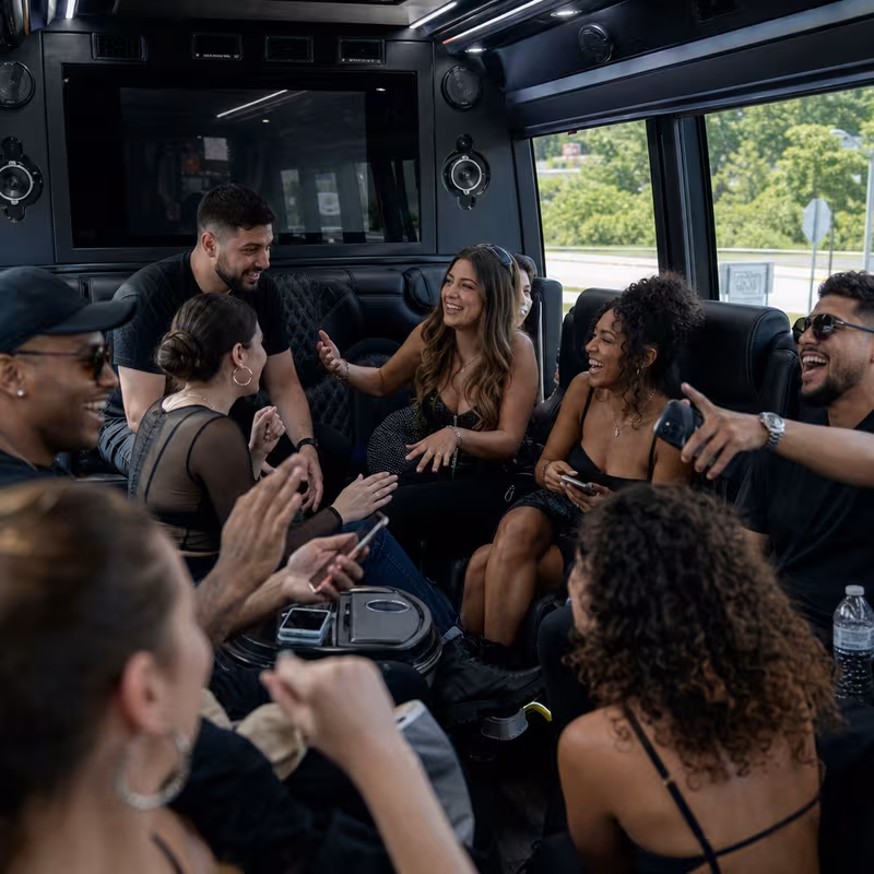 Group boarding a white charter bus for Concert Transportation transportation in Omaha