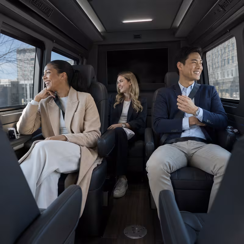 Passengers loading luggage while boarding an Omaha group shuttle