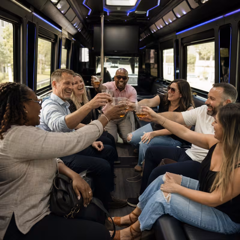 Group boarding a white charter bus for Winery & Brewery Tour Transportation transportation in Omaha
