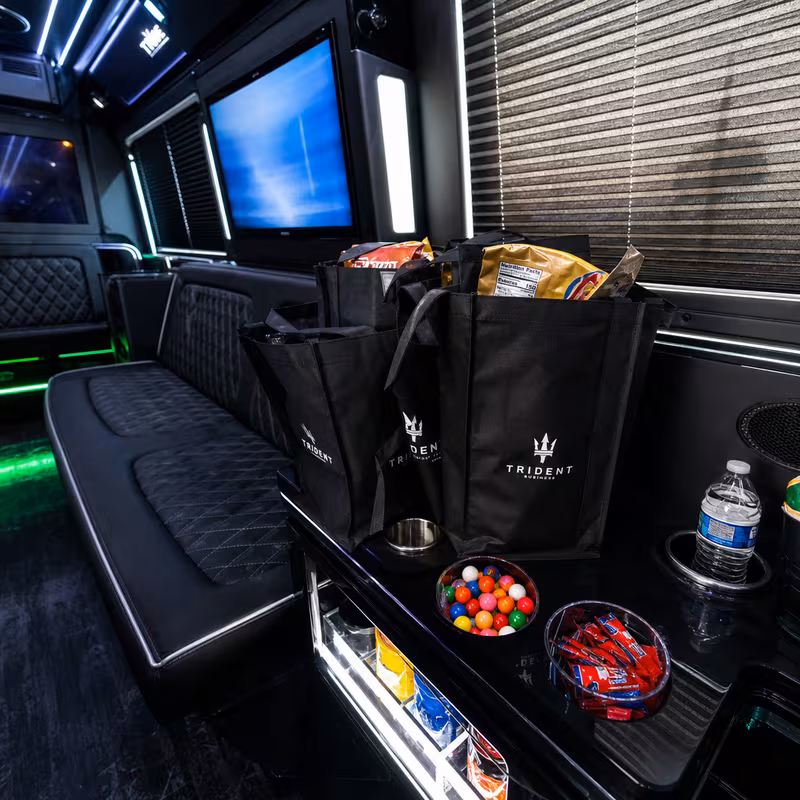 Party bus interior with wraparound leather seating and LED lighting in Omaha